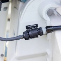 MarineWarehouse/Flushmaster-Flush-Port-Quick-Connect-installed-in-a-Honda-Outboard__50730.1739477310